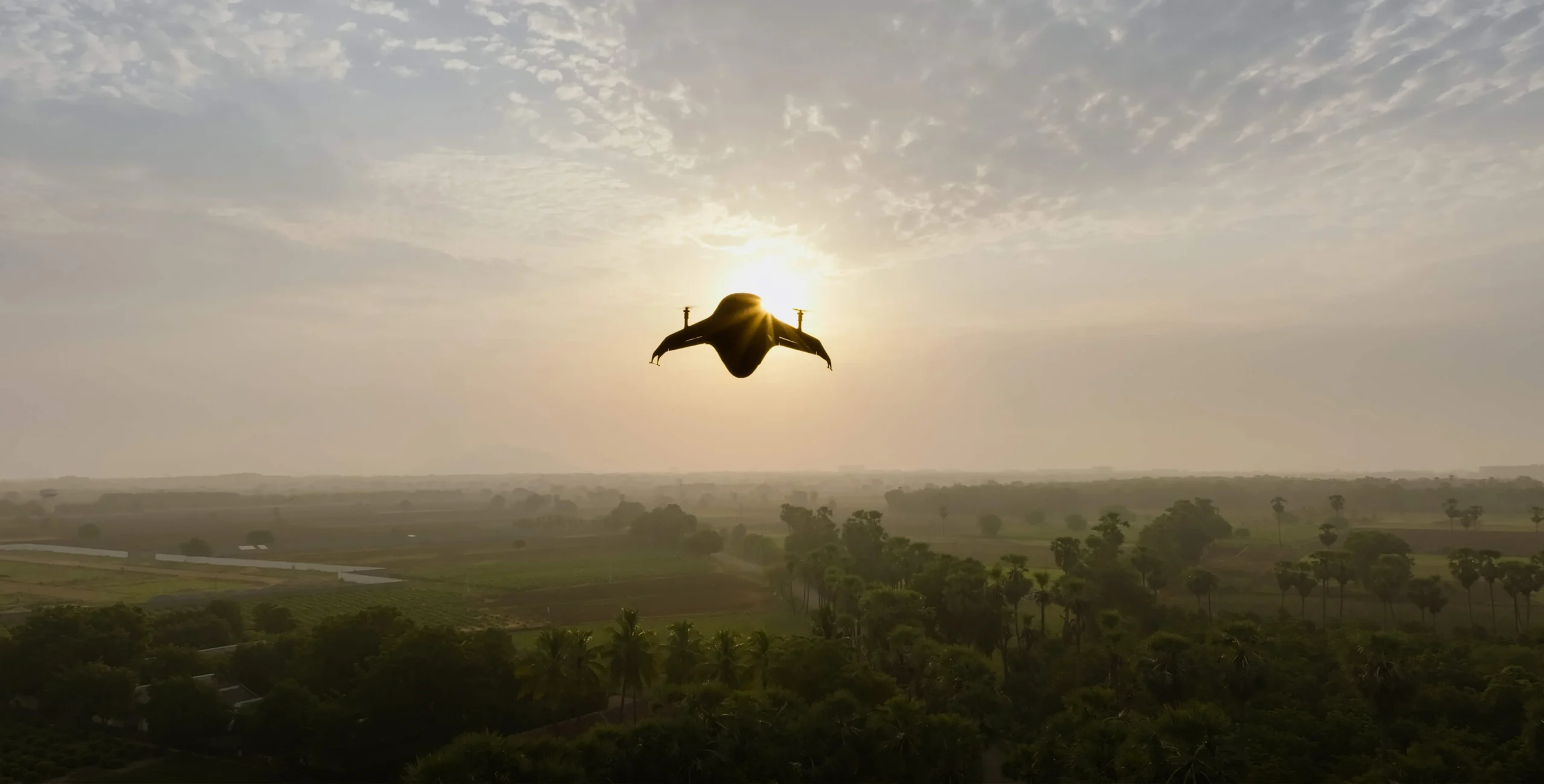 Airbound TRT tailsitter drone flying over the Andhra Pradesh countryside at sunrise