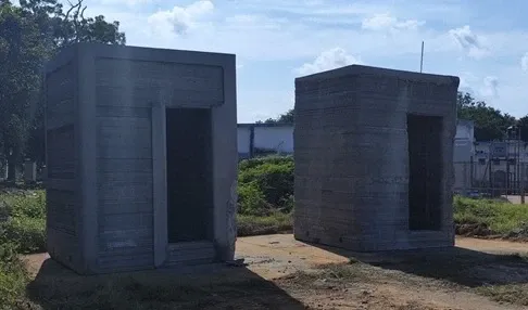 3D-printed toilet structures constructed on site by Kelvin6k's robotic printer