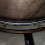 Close-up of a uniform robot weld bead on a steel vessel flange at xLogic's dark factory