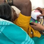 NIRAMAI's Thermalytix handheld device in use at a screening camp with phone app visible
