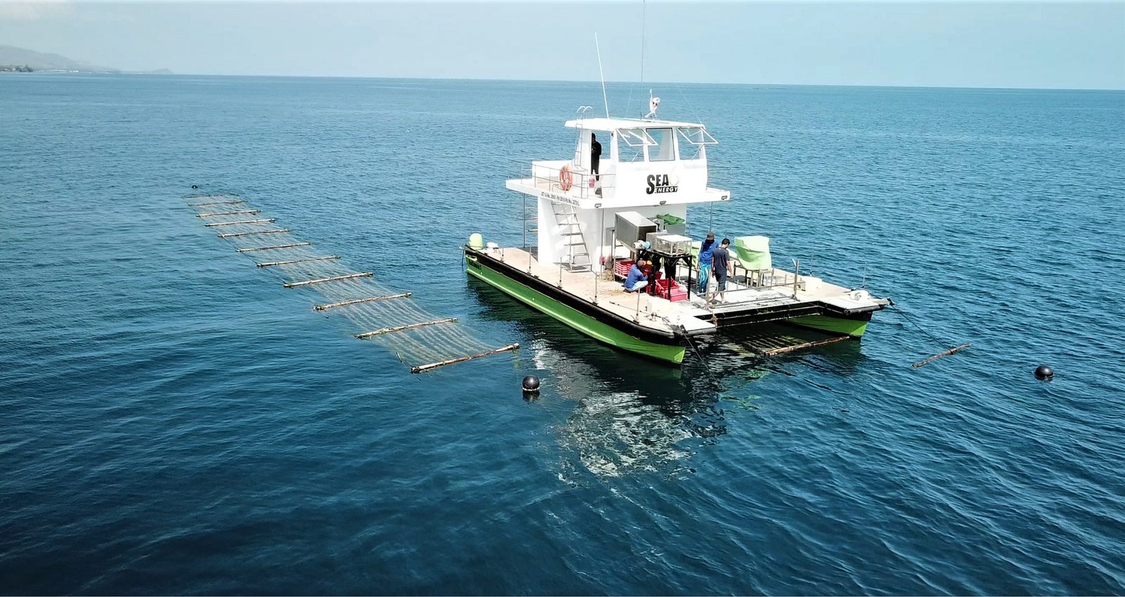 Alt text: Aerial view of mechanised tropical seaweed farm ocean