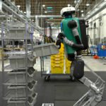 A humanoid robot at work in a fulfillment center — machines like this are trained on first-person video collected from Indian workers