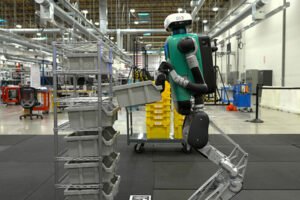 A humanoid robot at work in a fulfillment center — machines like this are trained on first-person video collected from Indian workers