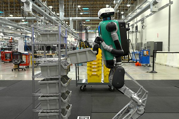 A humanoid robot at work in a fulfillment center — machines like this are trained on first-person video collected from Indian workers