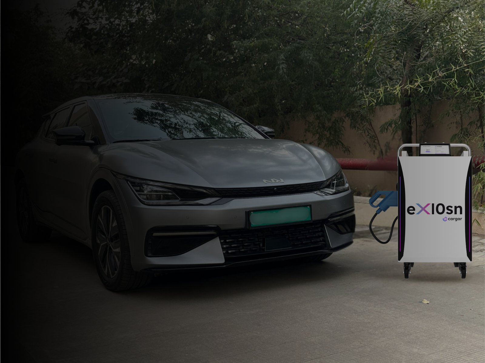 Alt text: Cargar's eX10sn portable DC fast charger on its trolley, charging a parked electric car