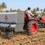 RAKSHAK, the AI-powered laser weeder from Harvested Robotics, mounted on a tractor in a field