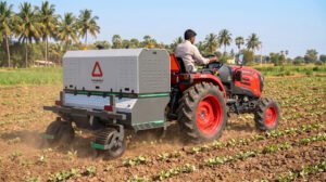 RAKSHAK, the AI-powered laser weeder from Harvested Robotics, mounted on a tractor in a field