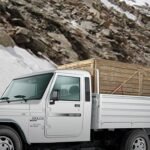 A commercial vehicle on a mountain road, fitted with Jamna Auto Industries suspension