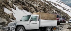 A commercial vehicle on a mountain road, fitted with Jamna Auto Industries suspension