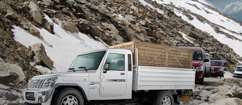 A commercial vehicle on a mountain road, fitted with Jamna Auto Industries suspension