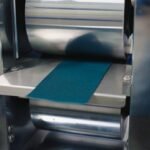 Macsen Energy roll press compressing a Prussian White sodium-ion cathode electrode strip
