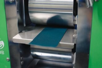 Macsen Energy roll press compressing a Prussian White sodium-ion cathode electrode strip