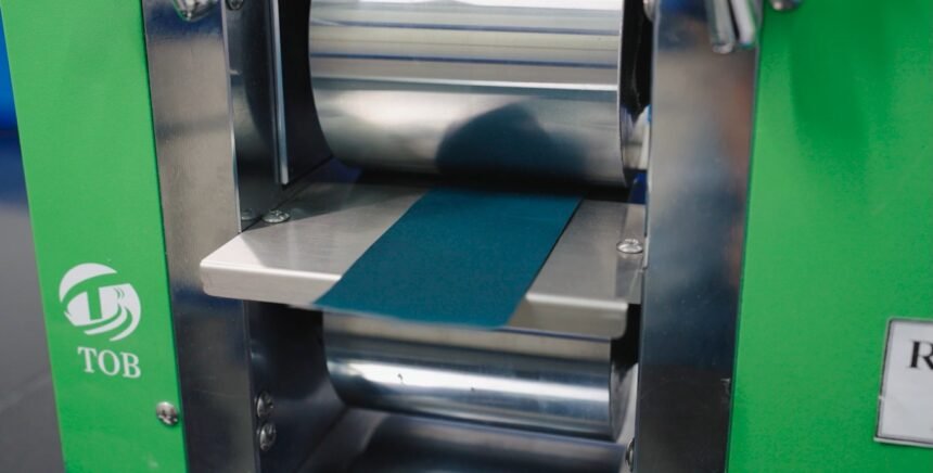 Macsen Energy roll press compressing a Prussian White sodium-ion cathode electrode strip