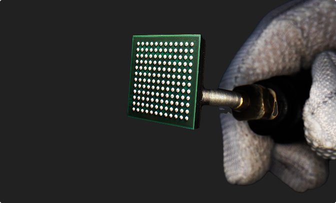 Packaged Secure IoT system-on-chip held in a gloved hand — official Mindgrove Technologies image