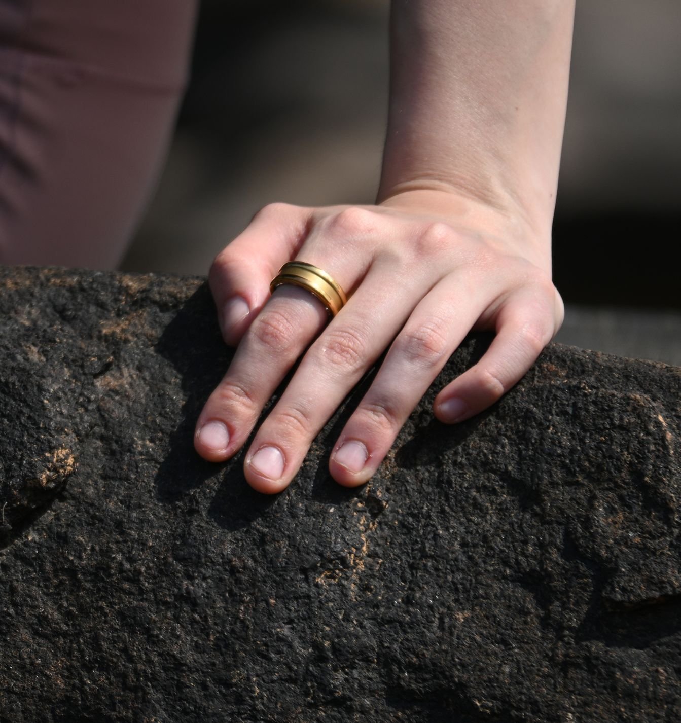 Muse Wearables' gold Ring One Gen 2 worn on a hand