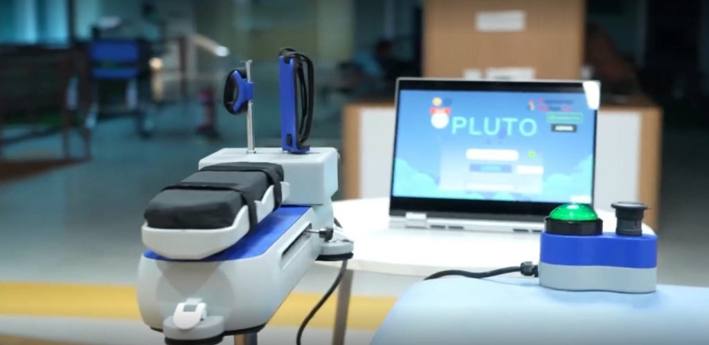 PLUTO-H beside its therapy game screen