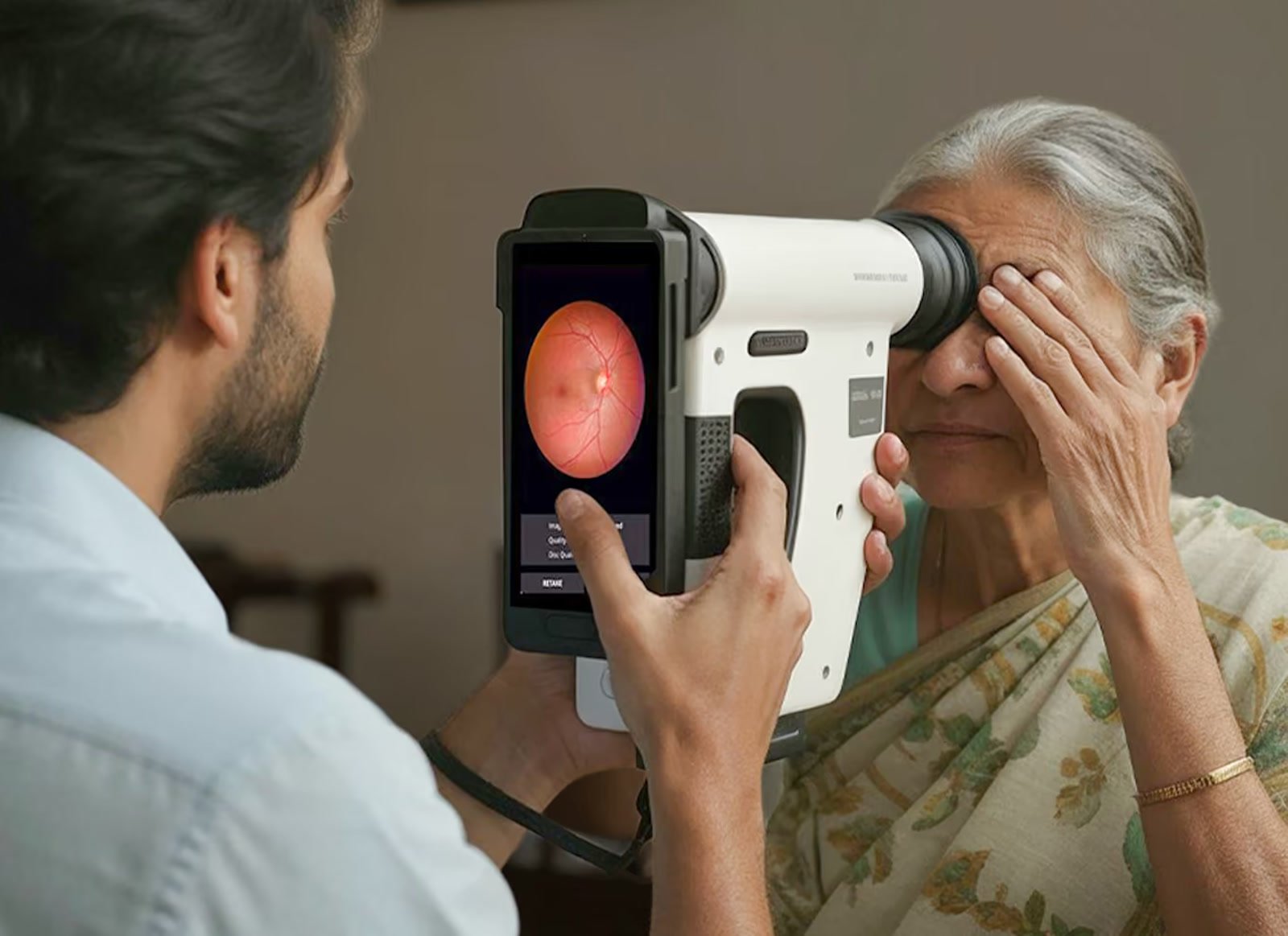 A health worker screening a patient with the Remidio Insta FOP NM-10