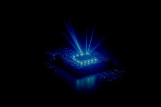 A chip rendered in blue on a circuit board — official Spintronics AI Semiconductors visual