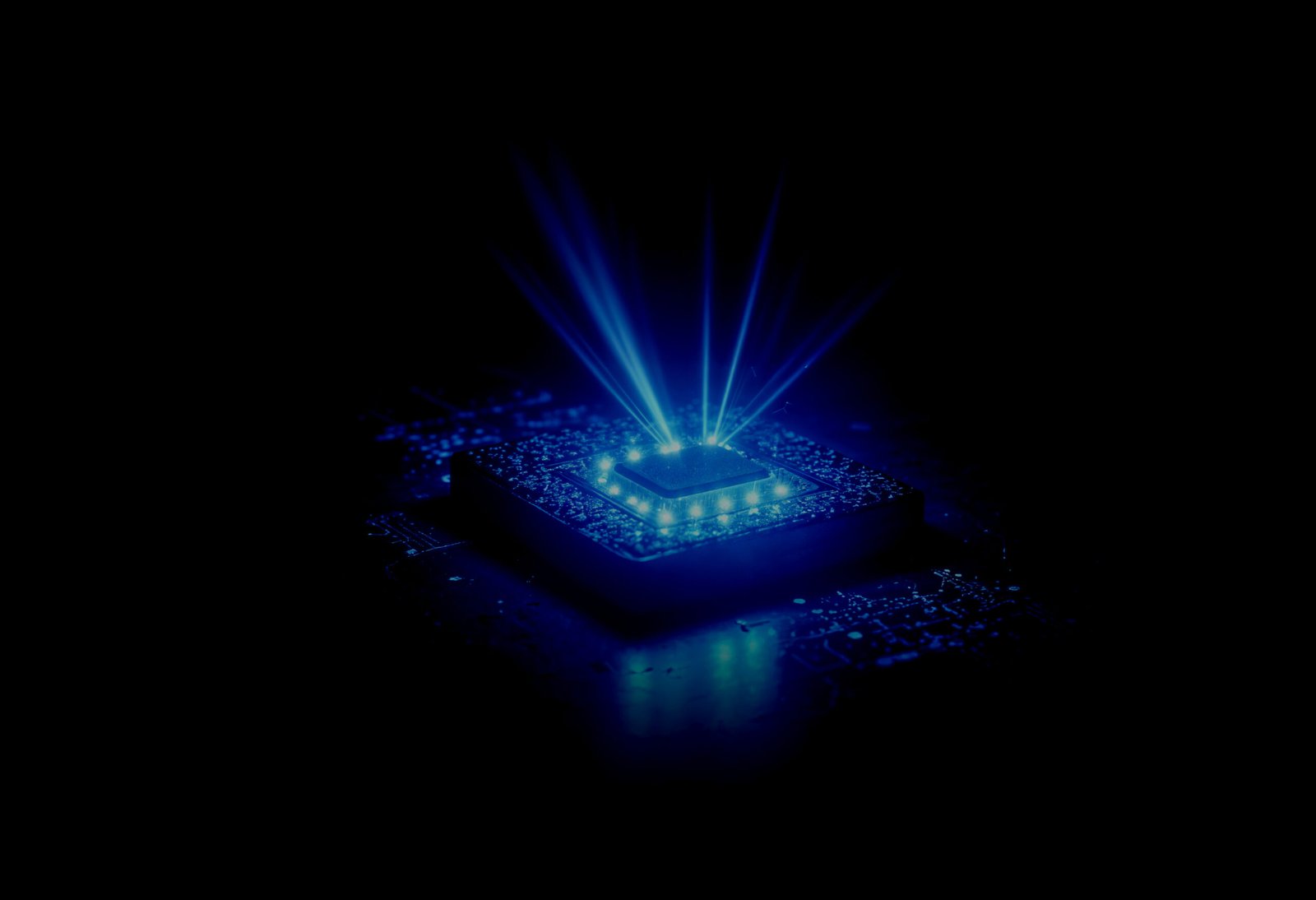 A chip glowing blue on a circuit board, the official Spintronics AI Semiconductors visual for its semiconductor work