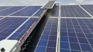 SudoYantra's waterless solar panel cleaning robot at work on a live solar farm