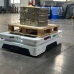 Tensrai autonomous mobile robot carrying a pallet in a warehouse
