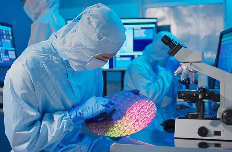 Tessolve Semiconductor engineer inspecting a silicon wafer