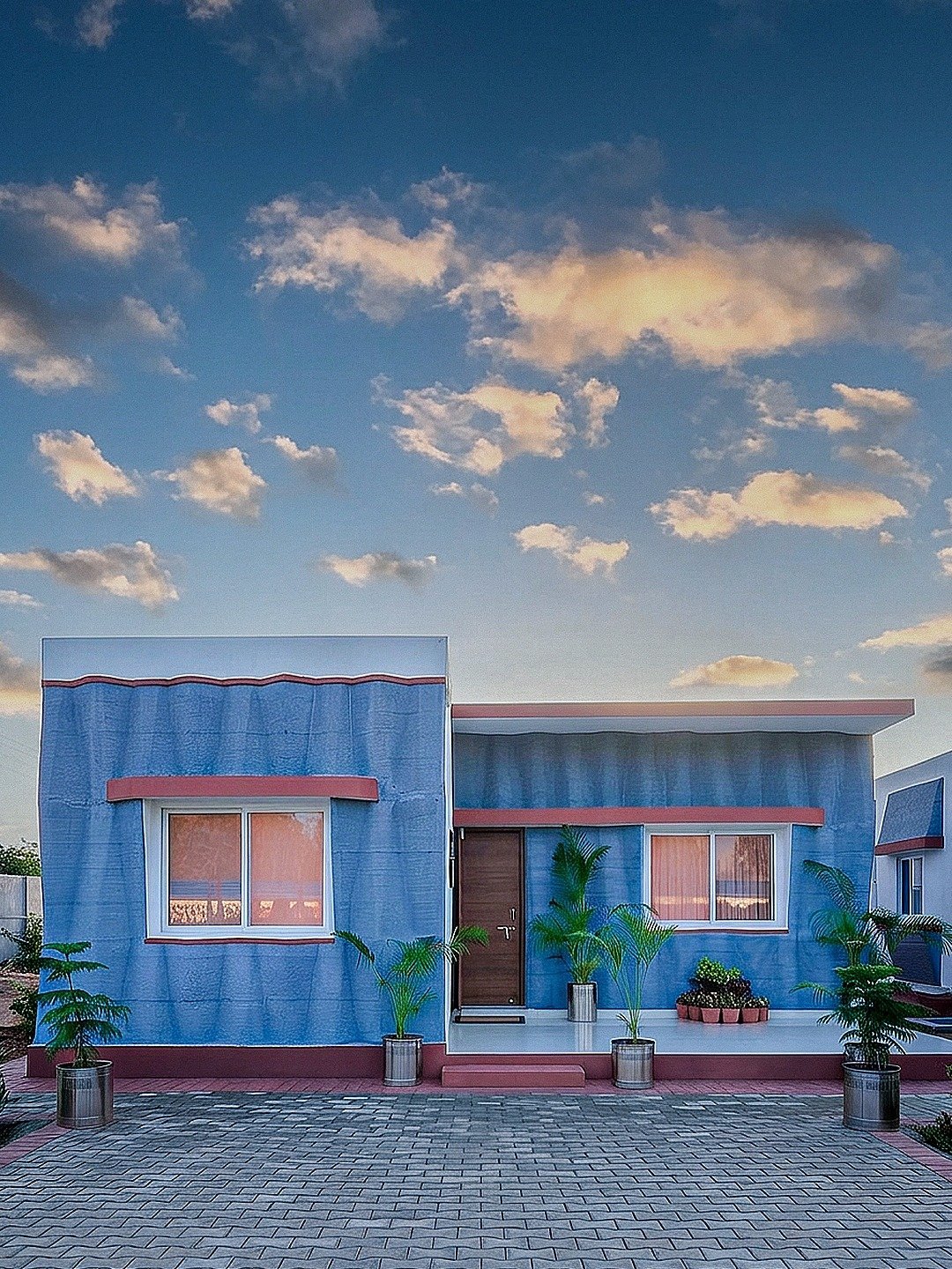 A blue 3D-printed house built by Tvasta