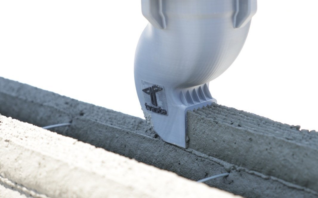 Tvasta 3D printer nozzle laying down layers of concrete