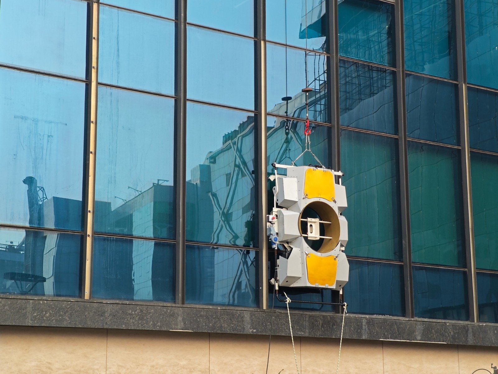 Vividobots Wiperque facade-cleaning robot at work on a high-rise glass facade